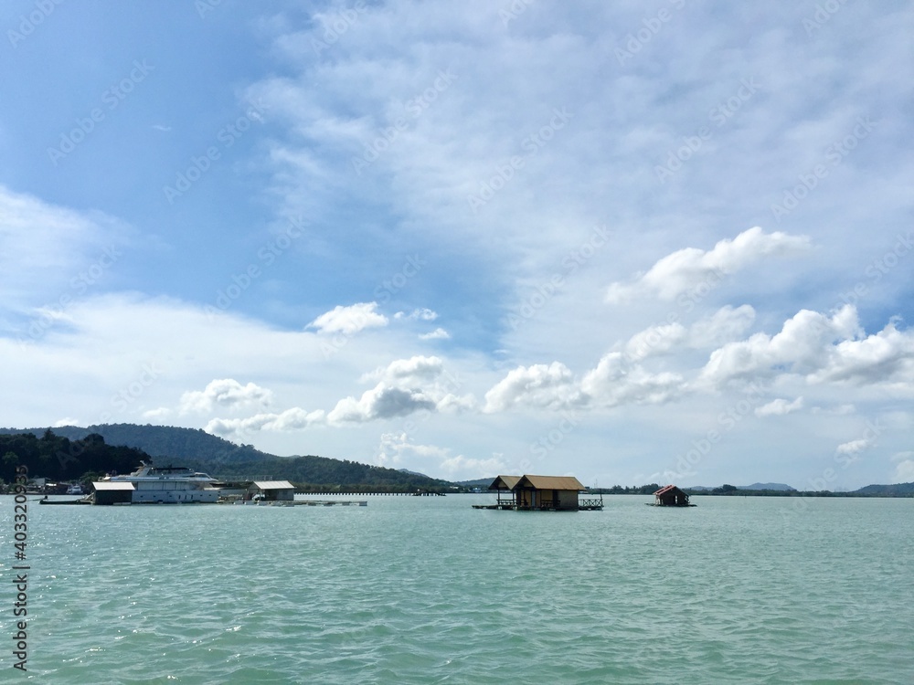 The landscape of the sea, the beautiful sky with many shapes of could, clearly mangrove sea, forest, fish cage and island in relax mode, Phuket Thailand.