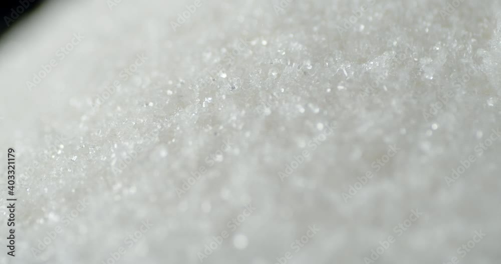 White sugar sand pours into a big pile. White sugar sand pours into a big pile.