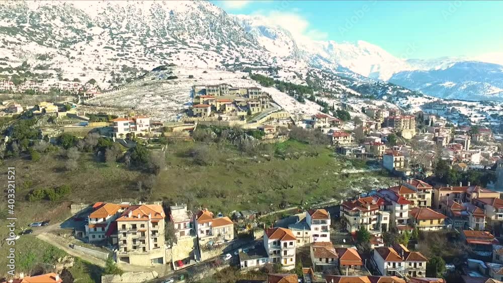 Aerial View, dolly over town houses and mountains with snow, GREECE Aerial View, dolly over town houses and mountains with snow, GREECE