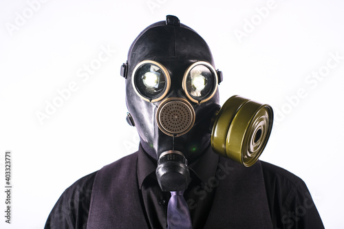 cosplay of a guy in a gas mask on a white background with glowing eyes © madnessbrains