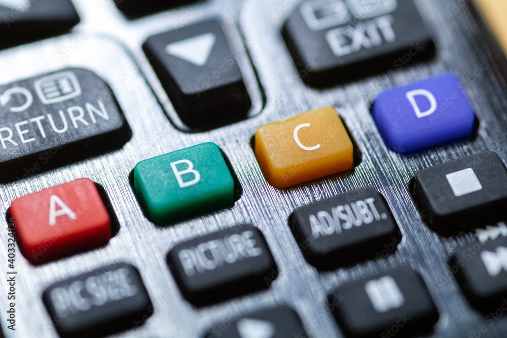 A B C and D coloured buttons close-up on TV remote control A B C and D coloured buttons close-up on TV remote control