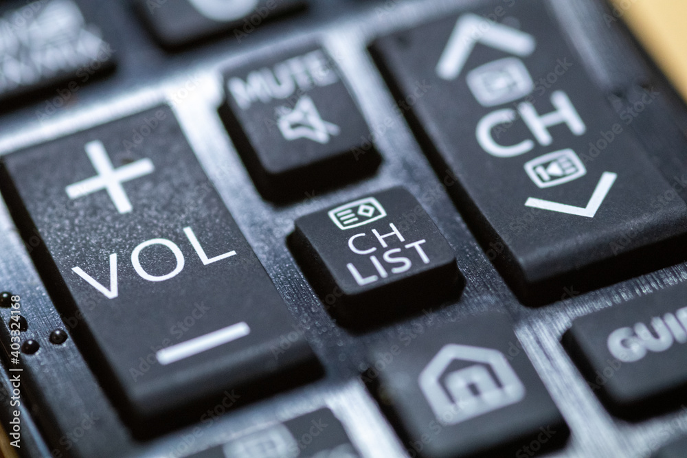 Volume button close-up on TV remote control with braille Volume button close-up on TV remote control with braille
