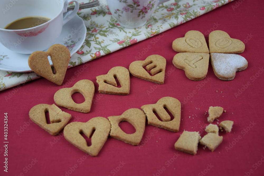 I love you too, inscription with cookies, drunk coffe, lipstic on cup, crumbs, red background, z humorem walentynki I love you too, inscription with cookies, drunk coffe, lipstic on cup, crumbs, red background, z humorem walentynki