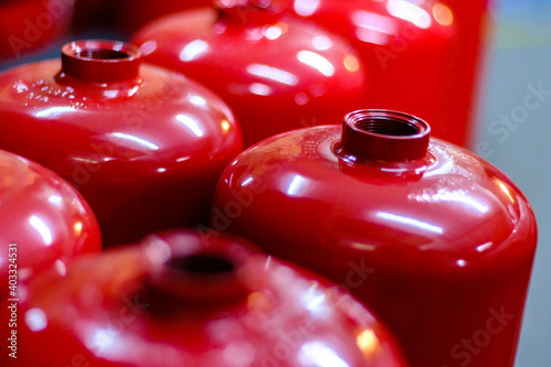 Top view of red empty fire extinguisher tanks in order waiting to be filled, safety first concept, selective focus