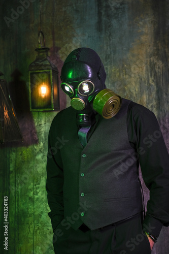 cosplay of a guy in a gas mask on a green background with glowing eyes © madnessbrains