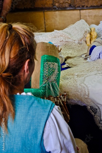 Gozo, Malta: Woman making Maltese lace (il-bizzilla), a style of bobbin lace made in Malta. It is a guipure style of lace worked as a continuous width on a tall, thin, upright pillow. photo