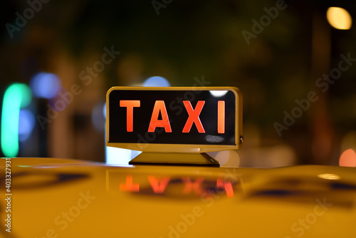taxi sign close-up in night city