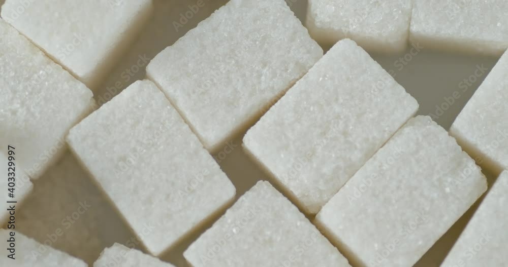 Sugar cubes on the table slowly rotate. Sugar cubes on the table slowly rotate.