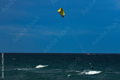 Kite surfing on a windy day offshore in Juno Beach Florida. photo