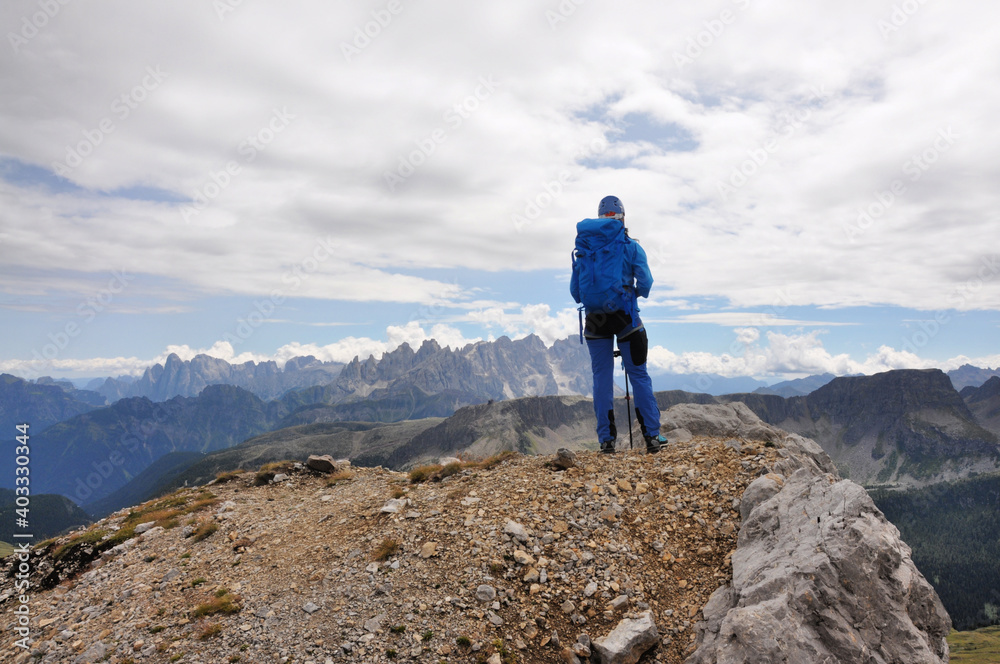 The women in blue stand at the top of the mountain, Dolomites, Italy