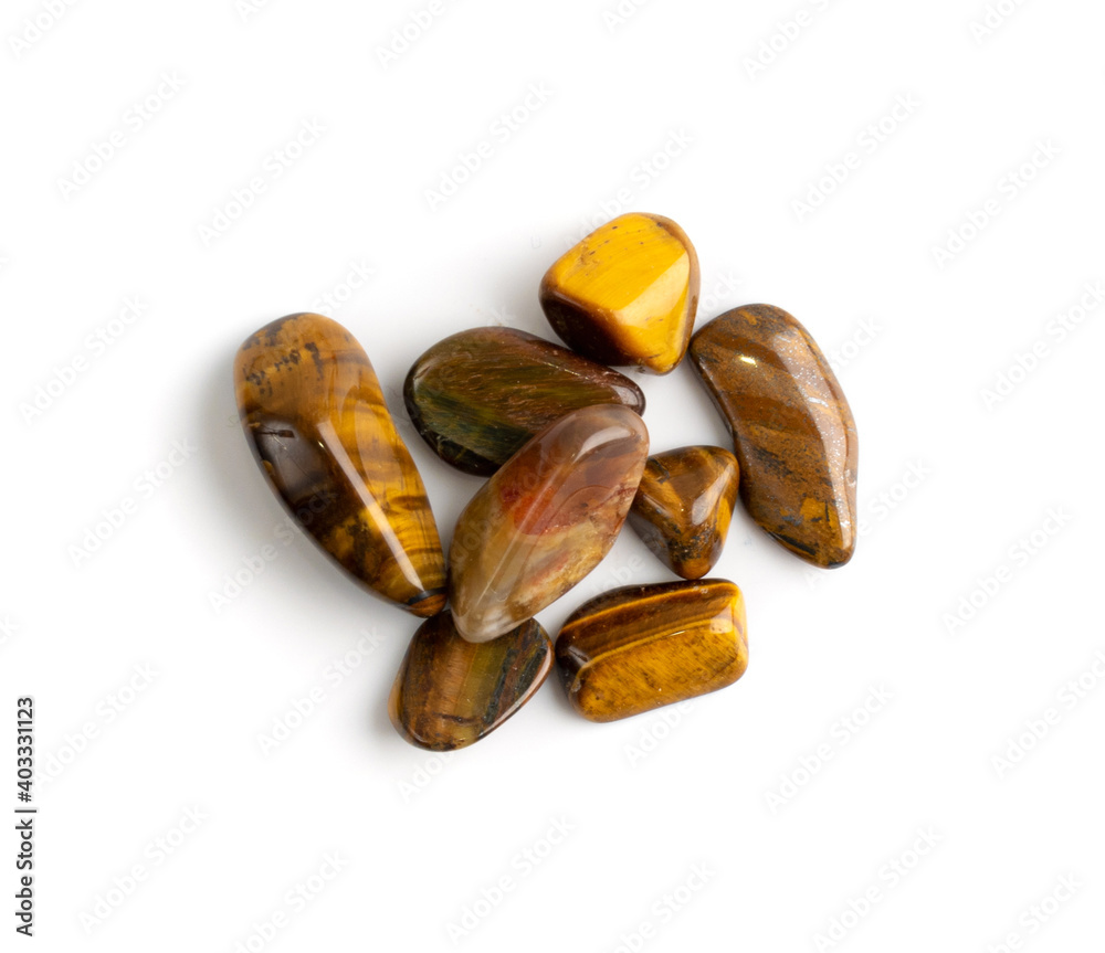 Tiger eye pebbles isolated, brown polished quartz stones Tiger eye pebbles isolated, brown polished quartz stones