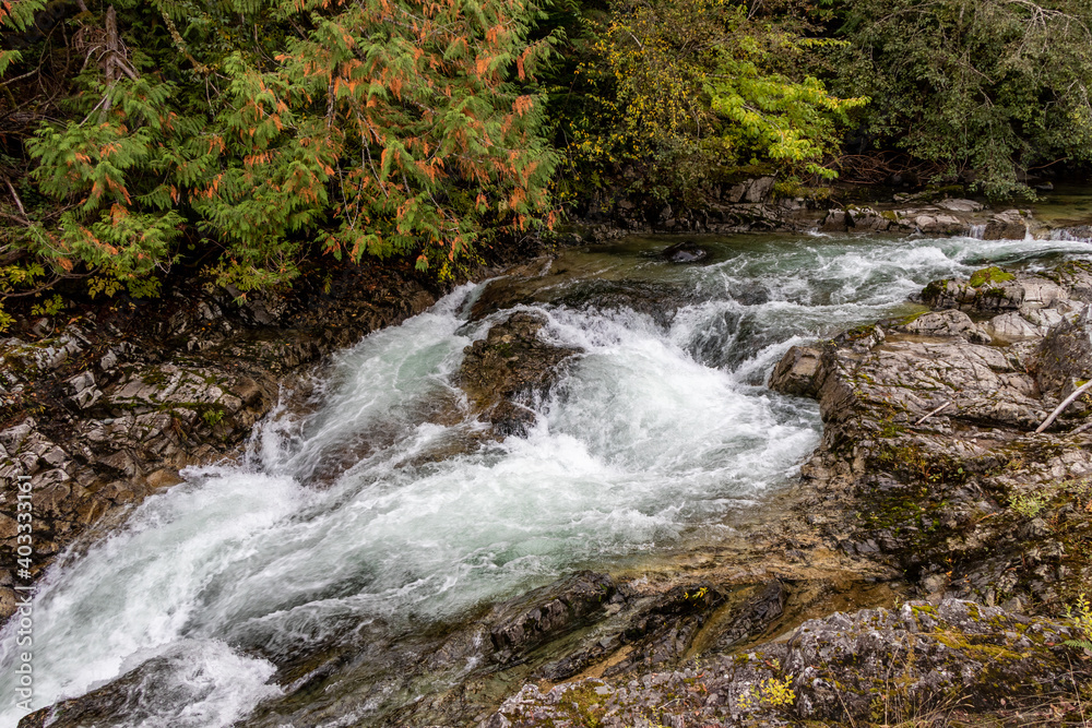 water rushing over rocks in a river at Little Qualicum Falls Provincial Park on Vancouver Island, Canada