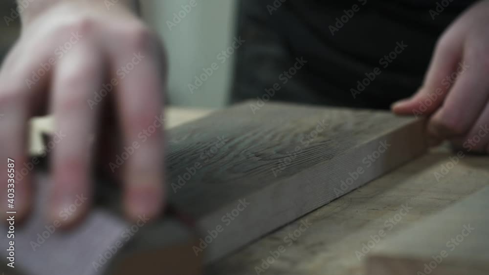 Closeup of Sanding Block Being Used on Edge of Wooden Plank Closeup of Sanding Block Being Used on Edge of Wooden Plank