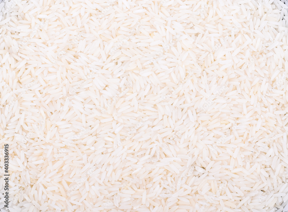 The arborio rice in wooden spoon isolated on white background. The arborio rice in wooden spoon isolated on white background.