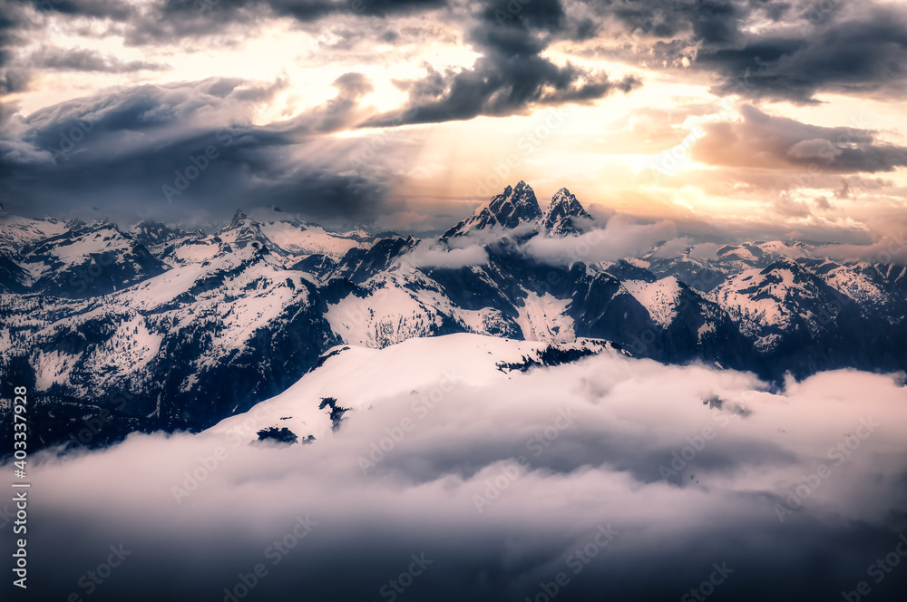 Dramatic Artwork. Aerial landscape view of the snow covered mountain range near Chilliwack and Vancouver, British Columbia, Canada. Artistic Sunset Sky Render