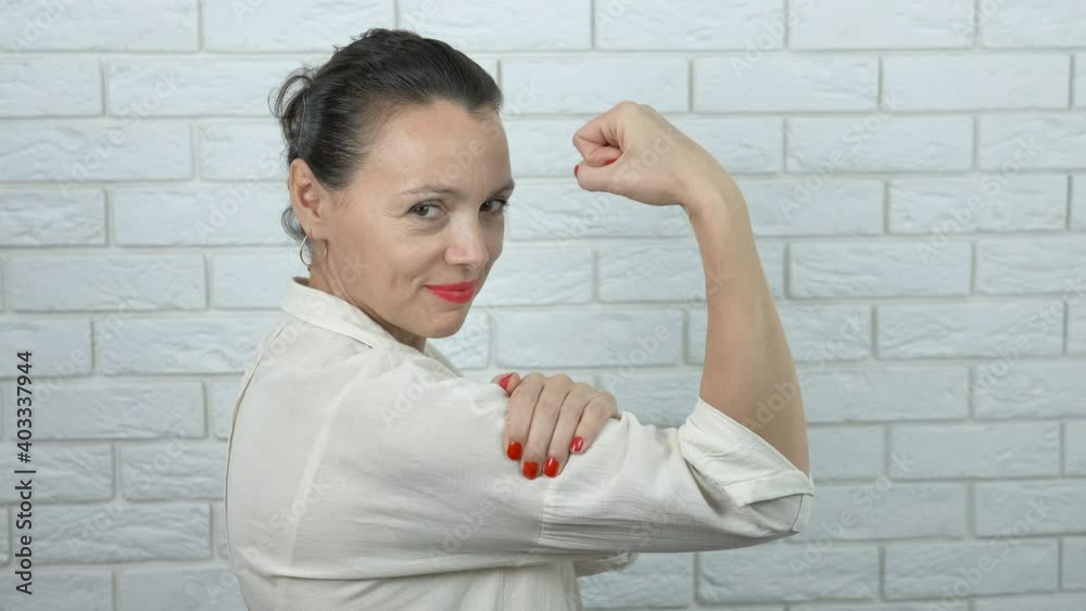 Improve woman power. Pretty woman shows strength in hand. Improve woman power. Pretty woman shows strength in hand.