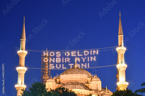 In Ramadan month Islamic message lettering hanging on Blue Mosque's mahya in Istanbul,Turkey. Mahya is an enlightenment arrangement during ramadan nights between two minarets. photo