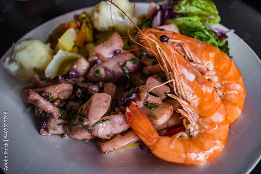 Dish with shrimp and composed with cuttlefish stew and vegetables with selective focus Dish with shrimp and composed with cuttlefish stew and vegetables with selective focus