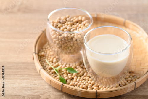 Soy milk and soy beans in a glass on bamboo tray, Healthy drink