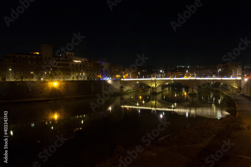 Night scene of Rome, Tevere river with city in background © elleonzebon