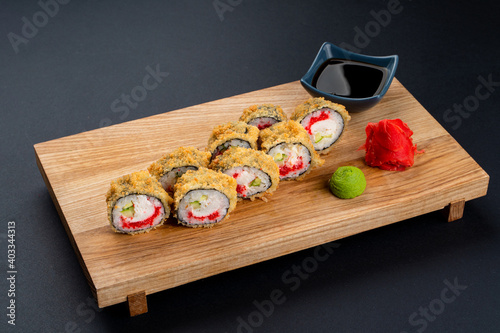 Nourishing japanese lunch: warm sushi with fresh,philadelphia cheese and caviar photo