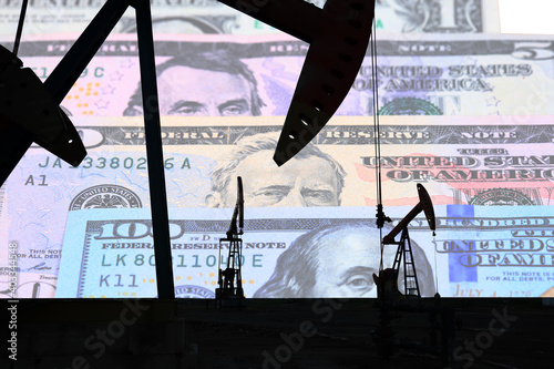 Petroleum, petrodollar and crude oil concept, Oil pump on background of US dollar