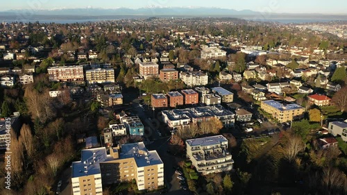 Cinematic drone reveal sunrise footage of East Queen Anne, Queen Anne, Westlake, upscale, affluent neighborhoods uptown by Puget Sound, in Seattle, Washington photo