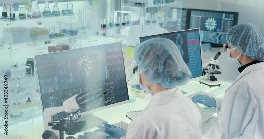Futuristic laboratory equipment - coronavirus and DNA testing. Side view of female scientists Futuristic laboratory equipment - coronavirus and DNA testing. Side view of female scientists