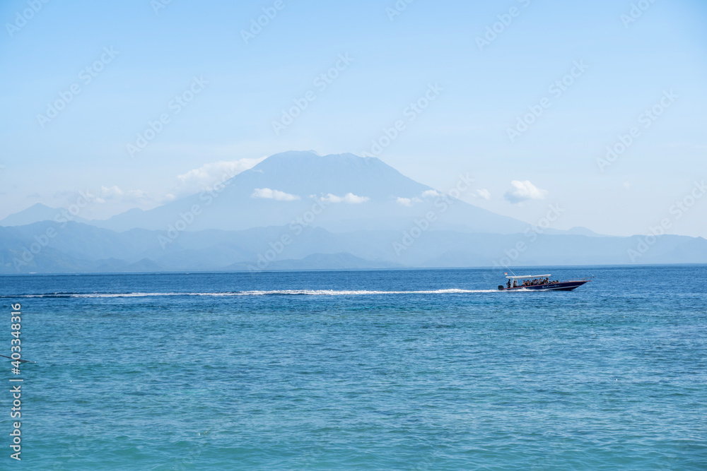 Beautiful beach and white sand with view of the volcano Mt Agung on Bali from Nusa Penida.