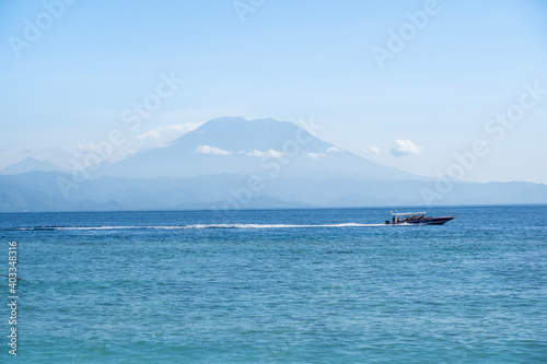 Beautiful beach and white sand with view of the volcano Mt Agung on Bali from Nusa Penida. © Trung Nguyen