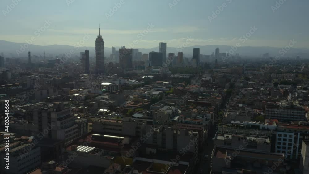 Drone Ascends to Reveal Mexico City Skyline in Background on Hazy Day Drone Ascends to Reveal Mexico City Skyline in Background on Hazy Day