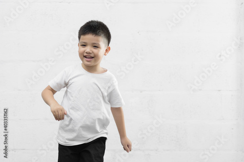 Smart little Asian boy studio portrait on background © Keopaserth