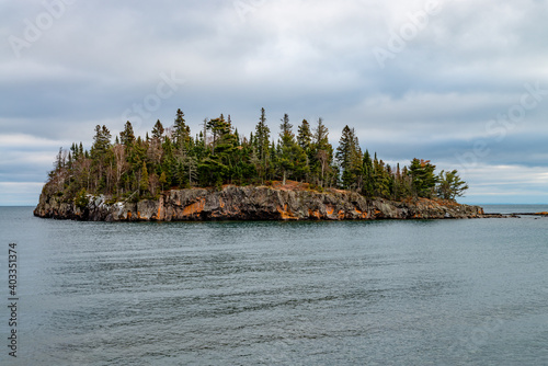 Fototapeta Naklejka Na Ścianę i Meble -  Island with coniferous trees and orange moss near lake Superior