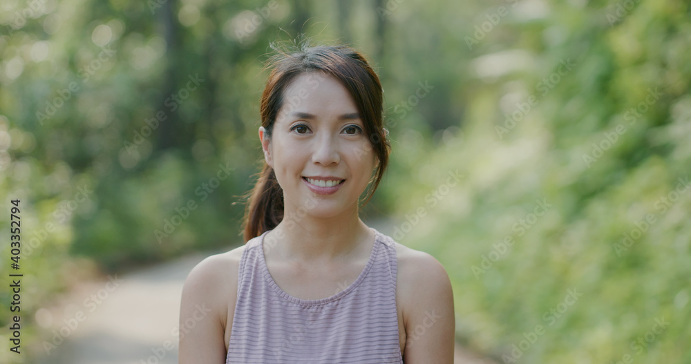 Woman smile to camera at park Woman smile to camera at park