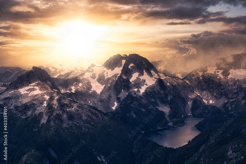 Aerial view of Canadian Mountain Landscape, Tantalus Range. Taken near Squamish, North of Vancouver, British Columbia, Canada. Dramatic Sunset Art Render
