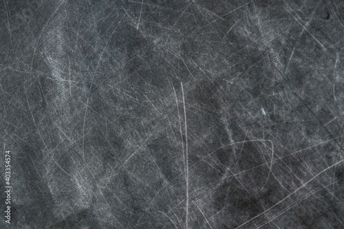 back to school: black chalkboard with blurry traces of white chalk and crayons, minor scratches