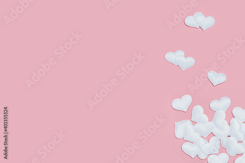 Valentines Day background with white hearts on pink colored. Greeting card or invitation for wedding cards. Pastel colors. © yrabota