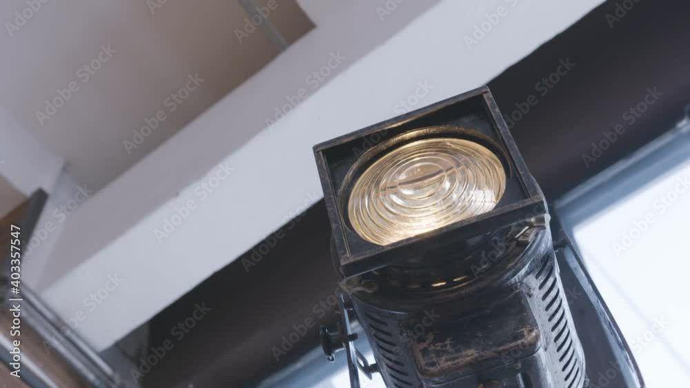 Flashing studio light. Action. Old studio lantern on wooden legs for