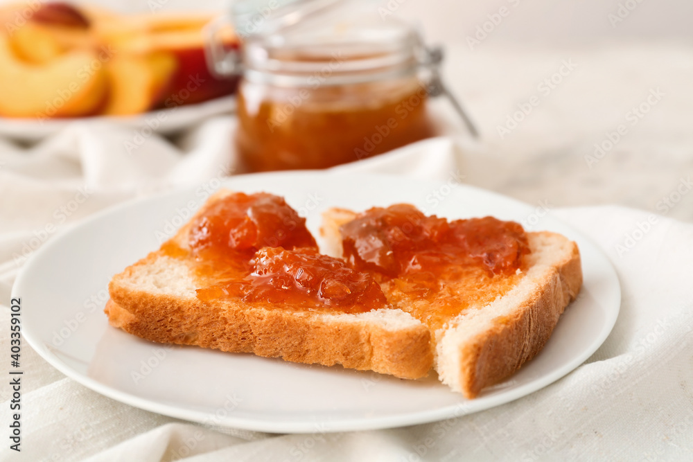 Bread with tasty peach jam on table Bread with tasty peach jam on table