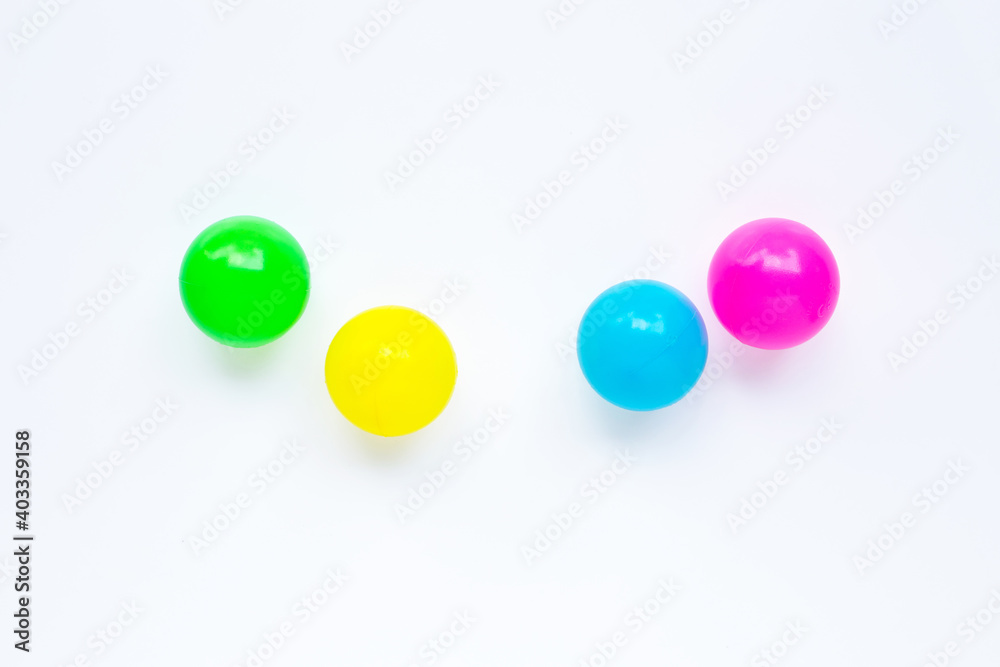 Colorful plastic balls on white background.