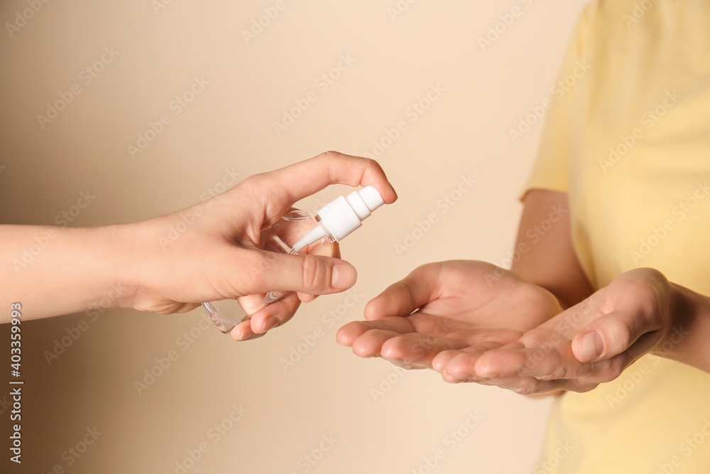 People with sanitizer on color background People with sanitizer on color background