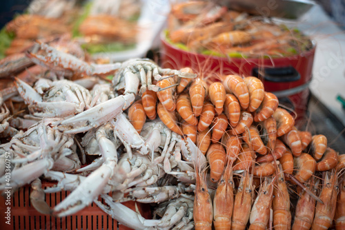 Streamed shrimp and seafood on the street market with soft focus and noise.