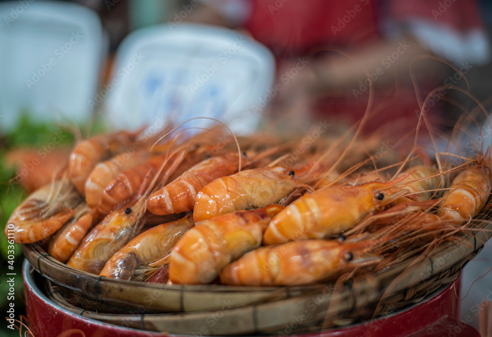 Streamed shrimp and seafood on the street market with soft focus and noise. Streamed shrimp and seafood on the street market with soft focus and noise.