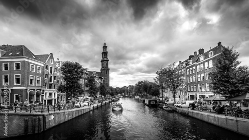 Black and White Photo of the Westertoren tower seen from the intersection of the Leliegracht and Prinsengracht canals in the Jordaan neighborhood