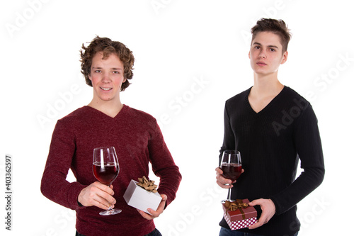 Holidays and weekends. Young attractive couple drinking red wine. White background. photo