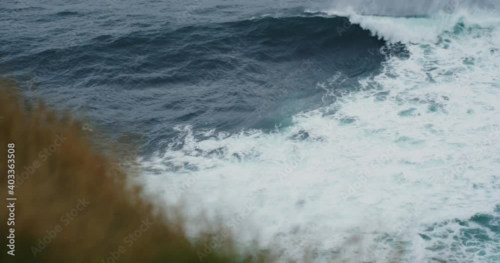 Heavy wave breaking in slow motion. Storm waves on sea or ocean rocks. Cliffs of Moher, Ireland. Blue water waves surface, beautiful cinematic background.  storm in the ocean sea .100 fps 