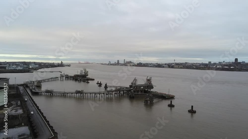 Drone view Tranmere oil terminal Birkenhead coastal petrochemical harbour distribution moving over Mersey photo