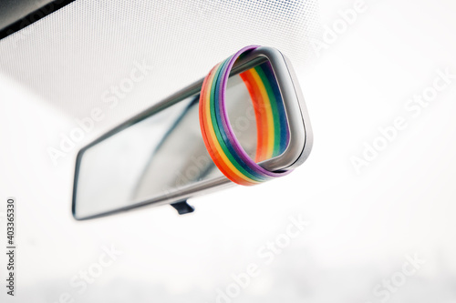 Принти на полотні LGBTQ paraphernalia on the rearview mirror in the interior of the car