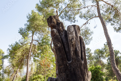 Dry tree trunk with two fingers cut out in the shape of Victory in the Totem park in the forest near the settlements of Har Adar and Abu Ghosh