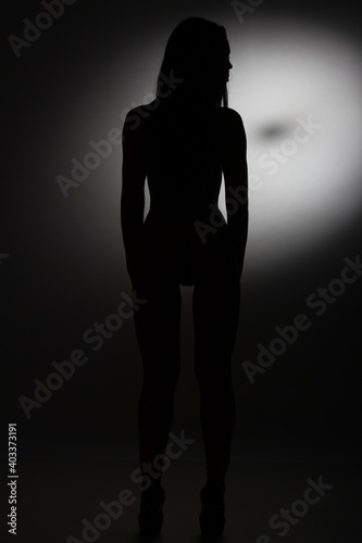Black and white silhouette of a young woman.